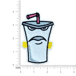 May include: An embroidered iron-on patch of a cartoon character. The character is a white cup with a pink straw, yellow ears, and a grumpy expression. The patch is approximately 2 inches tall.
