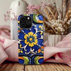 May include: A blue, yellow, and green phone case with a floral design. The case has a raised camera bump with three lenses.