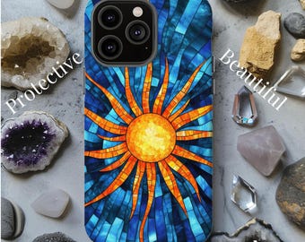 May include: A phone case with a stained glass design of a sun with orange rays against a blue background. The case has a cutout for the camera lens.