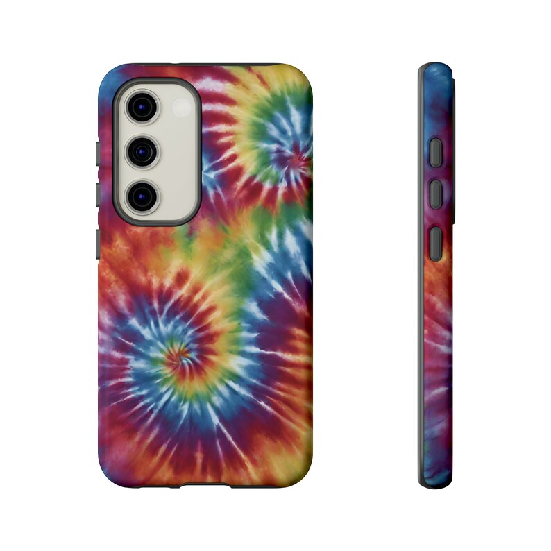 May include: A phone case with a tie-dye pattern in shades of red, blue, yellow, and green. The case has a cutout for the camera lens and buttons.
