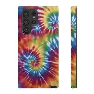 May include: A phone case with a colorful tie-dye pattern. The case has a cutout for the camera lens.