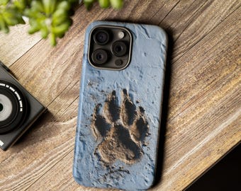 May include: A light blue phone case featuring a detailed paw print in a textured, earthy brown. The case has a dark camera module and is set against a wooden background, suggesting a nature or animal theme.