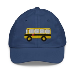 May include: A navy blue baseball cap with an embroidered yellow school bus on the front.