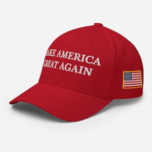 May include: Red baseball cap with white embroidery that reads "Make America Great Again". A small American flag is sewn on the right side of the cap.