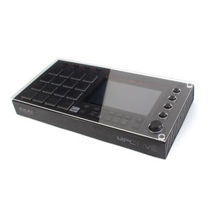May include: A black Akai MPC Live music production sampler with a clear acrylic protective cover. The cover has rounded corners and is secured with screws. The MPC Live has a large screen, 16 pads, and a variety of knobs and buttons.