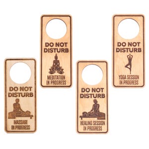 May include: Four wooden door hangers with the text "Do Not Disturb" and different illustrations. The illustrations include a meditating Buddha, a yoga pose, a massage therapist, and a person receiving a healing session. Each hanger has a hole at the top for hanging on a door.