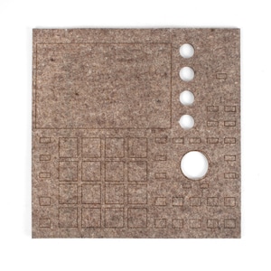 May include: A brown felt pad with a grid of squares, a circle, and a rectangular area for a screen. The pad is designed to be used with a music production controller.