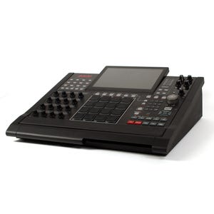 May include: A black Akai MPC music production centre with a large screen, numerous buttons, knobs, and pads. The device has a sleek, modern design, with red accents on some buttons. The Akai logo is visible on the top left.
