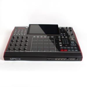May include: An Akai MPCX music production workstation in black and red. The MPCX features a large screen, 16 pads, and a range of knobs and buttons.