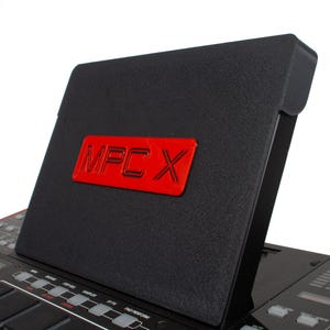 May include: A black MPC X music production workstation with a red logo that says "MPC X" on the top.