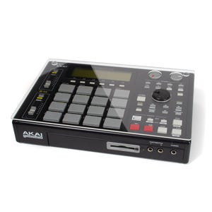 May include: Black Akai professional MPC60 drum machine with a clear acrylic cover. The drum machine has 16 pads, a display screen, and various buttons and knobs.