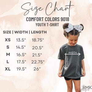 May include: A size chart for a Comfort Colors 9018 youth t-shirt. The chart lists sizes XS through XL with corresponding width and length measurements in inches. A diagram on the shirt indicates how to measure width and length for the garment.