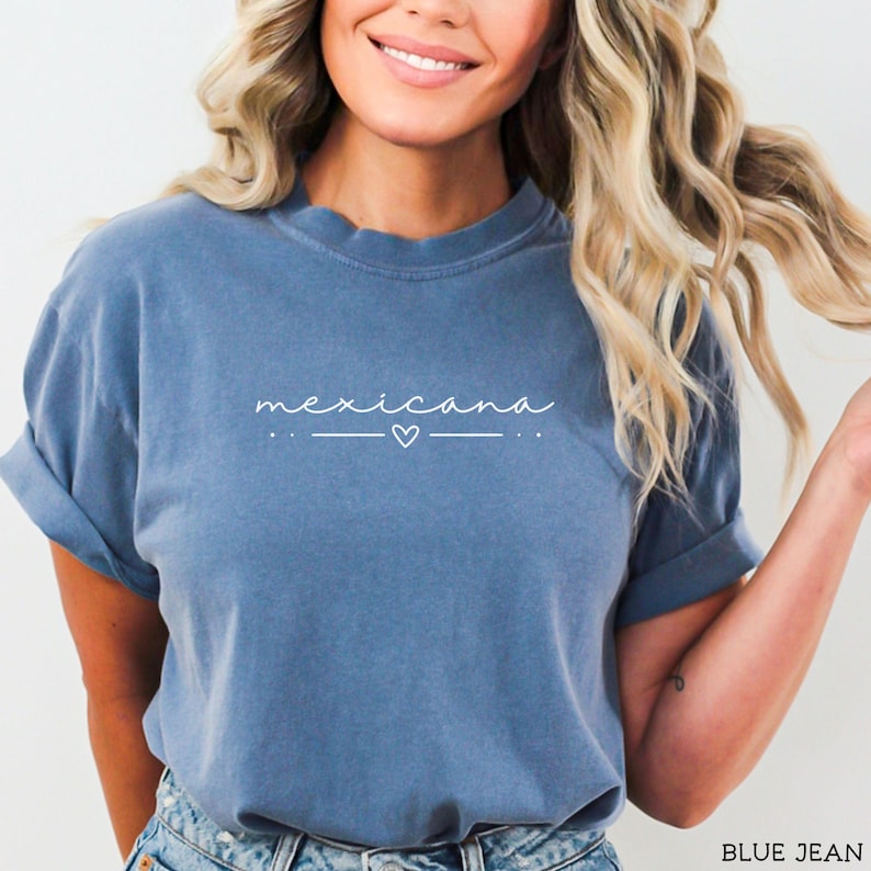 May include: A blue t-shirt with the word "mexicana" written in white cursive with a small heart above the word.