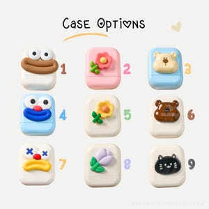May include: Nine colorful AirPod case options are displayed, each with a unique design. The cases feature cartoon characters, flowers, and a cat. The text "Case Options" is at the top. The cases are numbered 1 through 9.