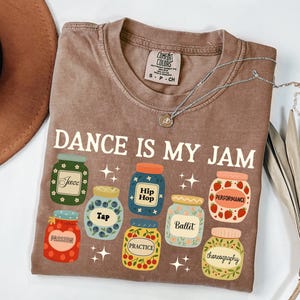 May include: A white ceramic mug with a black handle and the text "But First, Coffee" in a handwritten style. The mug is on a white surface. The mug is approximately 4 inches tall.