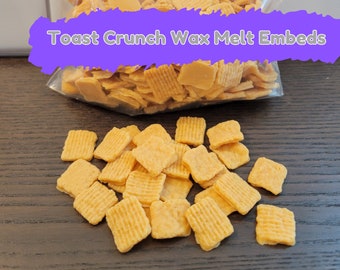 May include: A bag of golden brown Toast Crunch cereal squares, ready to be added to wax melts for a unique scent and visual appeal.  The bag is labeled "Toast Crunch Wax Melt Embeds".
