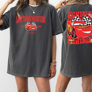 Disney Pixar Cars Shirt featuring Lightning McQueen in a vibrant design. This Comfort Colors® tee celebrates Radiator Springs and the iconic Piston Cup with a fun 'Cars Est. 2006' graphic. Perfect for Disney fans, whether you're visiting the parks or showing off your love for the Cars movie. Comfortable and stylish, this shirt is ideal for any Disney adventure, making it a great addition to your collection or a thoughtful gift for any Lightning McQueen fan