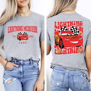 Disney Pixar Cars Shirt featuring Lightning McQueen in a vibrant design. This Comfort Colors® tee celebrates Radiator Springs and the iconic Piston Cup with a fun 'Cars Est. 2006' graphic. Perfect for Disney fans, whether you're visiting the parks or showing off your love for the Cars movie. Comfortable and stylish, this shirt is ideal for any Disney adventure, making it a great addition to your collection or a thoughtful gift for any Lightning McQueen fan