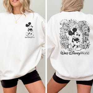 Mickey sketch sweatshirt inspired by Walt Disney World style. Cozy unisex crewneck sweatshirt perfect for Disney World vacation outfits and family matching looks. Soft and comfortable Disney trip sweatshirt ideal for park days, travel, or casual wear. Minimal sketch Mickey design makes this sweatshirt perfect for couples, families, or group Disney vacations. Cute and timeless Disney park apparel.