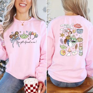 Disney Pixar Toy Story sweatshirt and hoodie featuring Woody, Buzz Lightyear, Rex, Hamm and Pizza Planet inspired design. Cozy unisex crewneck sweatshirt perfect for Disney park trips, Pixar fans, and family matching outfits. Soft and comfortable Disney sweatshirt ideal for Disneyland or Disney World vacations, travel days, or casual wear. Fun Toy Story sweatshirt great for kids at heart and Disney lovers.