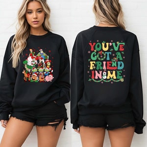 Celebrate the holidays with this festive Toy Story Christmas shirt featuring Woody, Buzz, and friends in a cheerful holiday design. Perfect for Disney family Christmas parties, group photos, or cozy winter park visits. Soft and vibrant, it’s a magical way to say "You've Got a Friend in Me" this season.