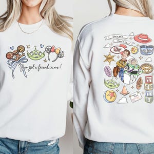 Disney Pixar Toy Story sweatshirt and hoodie featuring Woody, Buzz Lightyear, Rex, Hamm and Pizza Planet inspired design. Cozy unisex crewneck sweatshirt perfect for Disney park trips, Pixar fans, and family matching outfits. Soft and comfortable Disney sweatshirt ideal for Disneyland or Disney World vacations, travel days, or casual wear. Fun Toy Story sweatshirt great for kids at heart and Disney lovers.