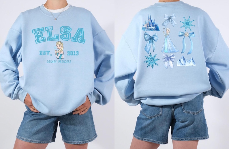 Elsa two sided bow sweatshirt and hoodie inspired by Frozen Disney princess style. Cozy unisex crewneck sweatshirt featuring front and back bow design aesthetic. Perfect Disney girls trip sweatshirt for Disneyland and Disney World vacations. Soft and comfortable Disney sweatshirt ideal for park outfits, travel days, or casual wear. Cute coquette Elsa sweatshirt great for girls, friends, and Disney fans.