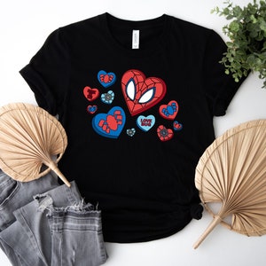 May include: Black t-shirt with a red and blue graphic of a spider-man character with hearts and the text "Love Bug".