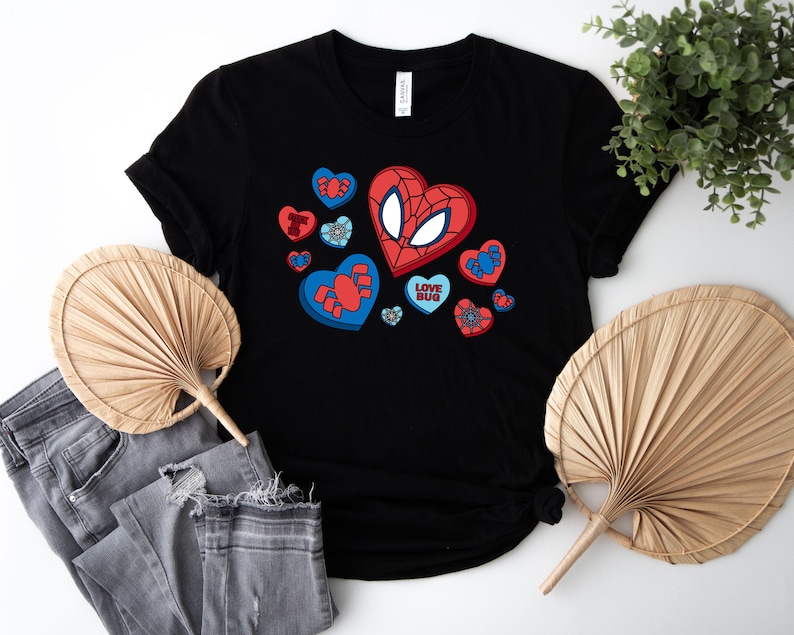 May include: Black t-shirt with a red and blue graphic of a spider-man character with hearts and the text "Love Bug".