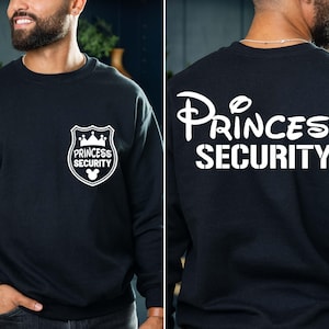 Princess Security Shirt – a funny and stylish Dad sweatshirt, perfect for Disney dads! Whether you're keeping the little ones safe at Disneyland or looking for a unique gift, this shirt is great for Father’s Day, birthdays, or as a gift for your boyfriend. Ideal for a Disneyland family trip, this shirt adds a fun touch to your Disney adventures while showing off your dad pride. Comfy, humorous, and perfect for making memories with your family!