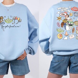 Disney Pixar Toy Story sweatshirt and hoodie featuring Woody, Buzz Lightyear, Rex, Hamm and Pizza Planet inspired design. Cozy unisex crewneck sweatshirt perfect for Disney park trips, Pixar fans, and family matching outfits. Soft and comfortable Disney sweatshirt ideal for Disneyland or Disney World vacations, travel days, or casual wear. Fun Toy Story sweatshirt great for kids at heart and Disney lovers.