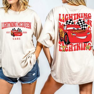 Disney Pixar Cars Shirt featuring Lightning McQueen in a vibrant design. This Comfort Colors® tee celebrates Radiator Springs and the iconic Piston Cup with a fun 'Cars Est. 2006' graphic. Perfect for Disney fans, whether you're visiting the parks or showing off your love for the Cars movie. Comfortable and stylish, this shirt is ideal for any Disney adventure, making it a great addition to your collection or a thoughtful gift for any Lightning McQueen fan