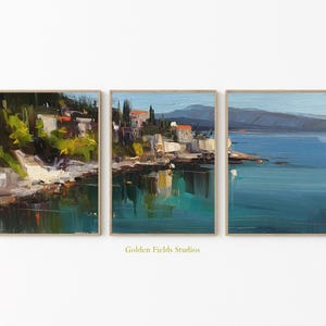 May include: Three framed landscape paintings showcasing coastal scenes with buildings, water, and mountains. The artwork uses blues, greens, and earth tones, with visible brushstrokes. The text "Golden Fields Studios" is at the bottom.