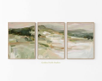 May include: Set of three framed landscape paintings with abstract brushstrokes in muted tones of green, beige, and pink. The artwork features a natural, serene scene with a soft, painterly effect. The text "Golden Fields Studios" is at the bottom.