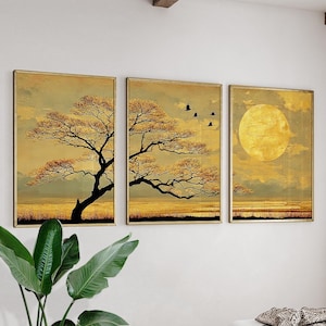 May include: Three framed wall art pieces. Each piece features a golden landscape with a tree, birds, and a large sun or moon. The artwork has a vintage, textured appearance with a warm colour palette of gold, brown, and black.