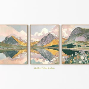 May include: A triptych of framed landscape prints. Each print depicts a mountain range reflected in a lake, with a colour palette of yellow, green, and pink. The artwork is in a watercolour style, with a soft, dreamy aesthetic.