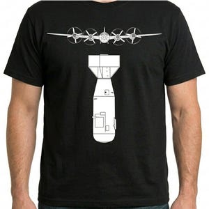 May include: Black t-shirt featuring a white graphic of a bomber plane above a bomb. The design is a detailed line drawing. The shirt is a classic crew neck style.