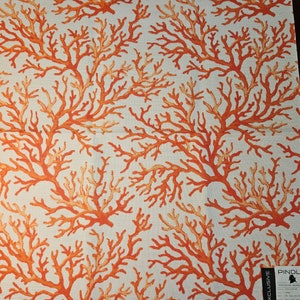 May include: White fabric with a repeating pattern of orange coral branches. The fabric has a label that reads "Pindler Exclusive Outdoor Sunbrella Performance Fabric"