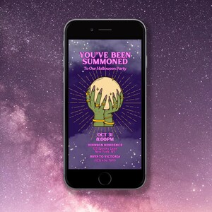 May include: A smartphone screen displaying a Halloween party invitation with a spooky, mystical theme. The invitation features a pair of green hands holding a crystal ball with a golden rim, surrounded by a starburst effect. The text reads "You've Been Summoned to Our Halloween Party" and includes the date, time, location, and RSVP information.