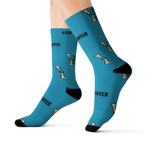 May include: A pair of blue socks with a white bone graphic and the text "The Bone Zone" repeated on the socks.