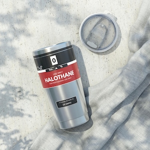 May include: A stainless steel tumbler with a red and white label that reads "0 Vol. % USE ONLY HALOTHANE FOR PROFESSIONAL USE ONLY" and a black label that reads "IF FOUND RETURN TO DR SMITH".