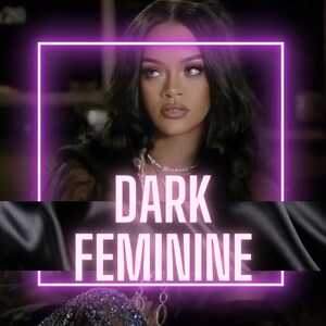 May include: A woman with dark hair and makeup, wearing a black outfit and a silver necklace. The text "DARK FEMININE" is written in pink neon letters.