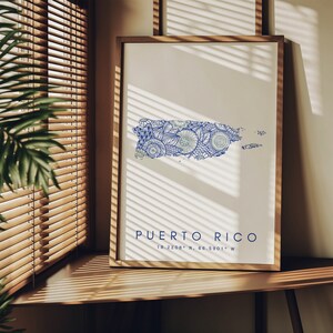 May include: A framed print of a map of Puerto Rico with a blue and white mandala design. The text "PUERTO RICO 18.2208&deg; N, 66.5901&deg; W" is printed below the map.