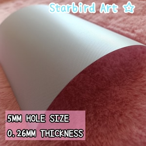 May include: A sheet of gray perforated material with a curved shape. The text on the image reads: .5MM HOLE SIZE, 0.26MM THICKNESS. The material is on a pink, fuzzy surface. The top right corner has the text "Starbird Art".