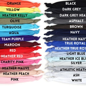 May include: A color chart of 20 different t-shirt colors, including orange, yellow, olive, turquoise, aqua, team purple, maroon, red, heather red, charity pink, heather mauve, heather peach, pink, black, dark grey, dark grey heather, asphalt, brown, navy, heather navy, true royal, heather true royal, light blue, heather ice blue, silver, athletic heather, ash, and white.