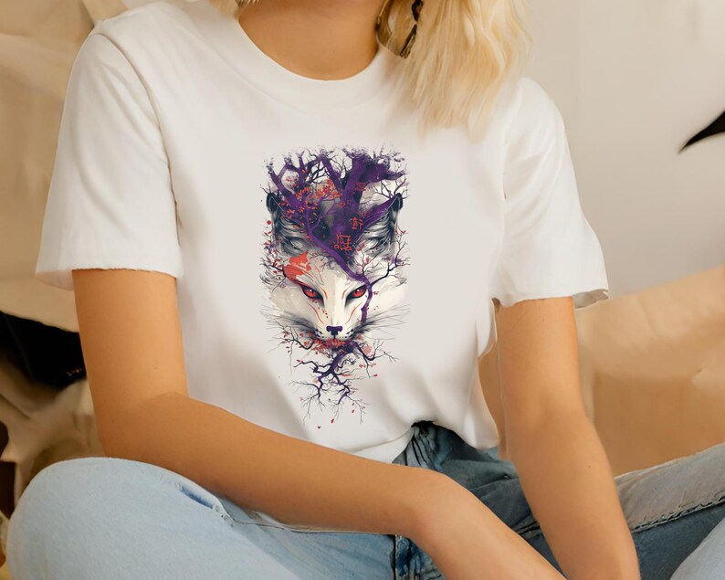 May include: White t-shirt with a graphic print of a white fox with purple and red accents. The fox is surrounded by branches and flowers.
