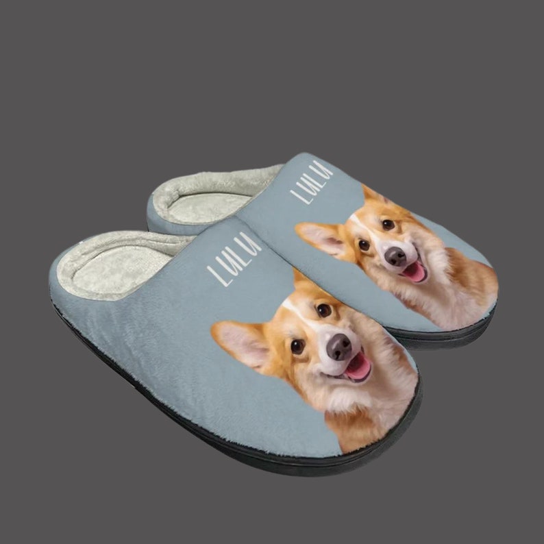 May include: A pair of blue fleece slippers with a personalized dog portrait and the name "LULU" printed on each slipper.