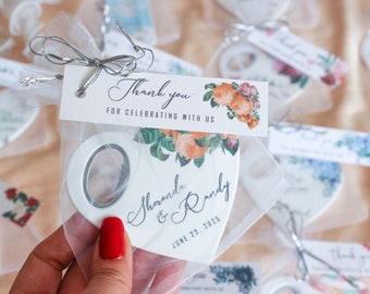 May include: White heart-shaped bottle opener with a floral design and the text "Thank you for celebrating with us" and "Shononda & Randy June 20, 2025".