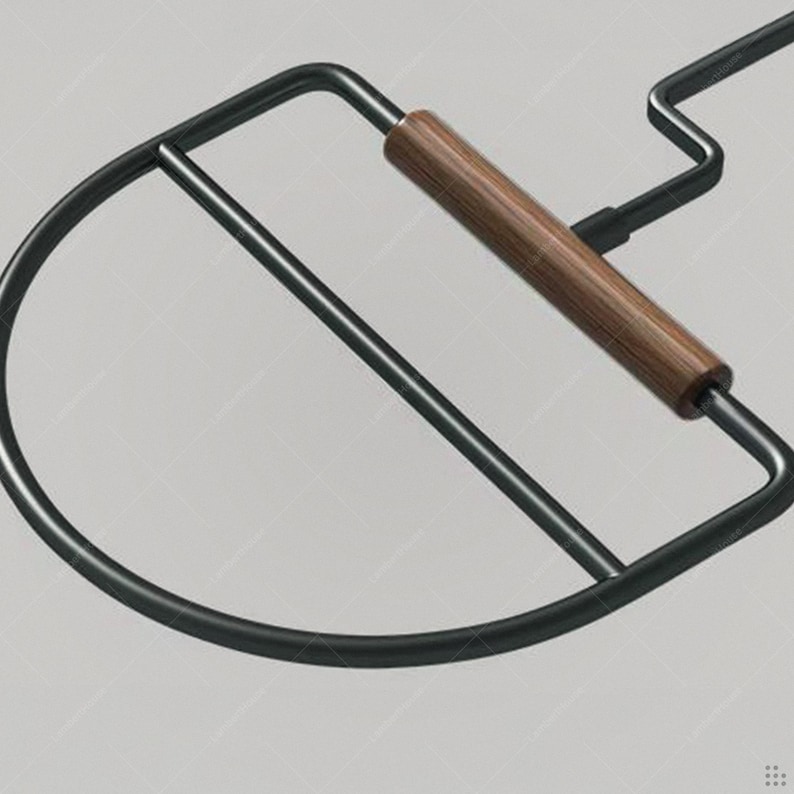 May include: A black metal chair frame with a curved back and a wooden handle. The chair has a minimalist design and a modern aesthetic. The wooden handle is a warm brown color.