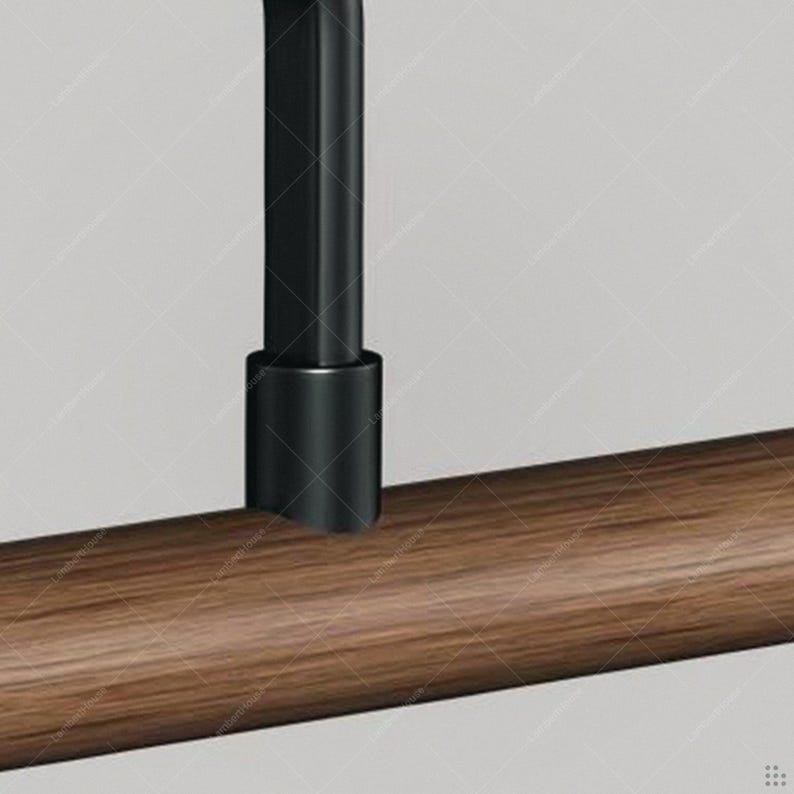May include: Close-up of a modern, minimalist clothing rack. The rack features a dark brown wooden bar and a black metal support. The design is simple and elegant, suitable for a contemporary bedroom or closet.